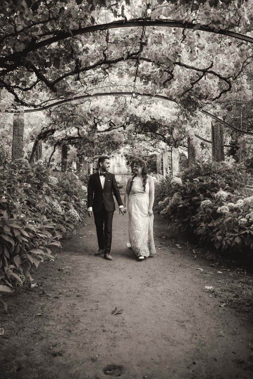 Couple walking under a vine pergola