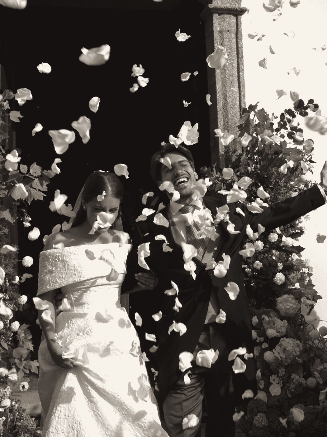Couple leaving the church under a shower of petals