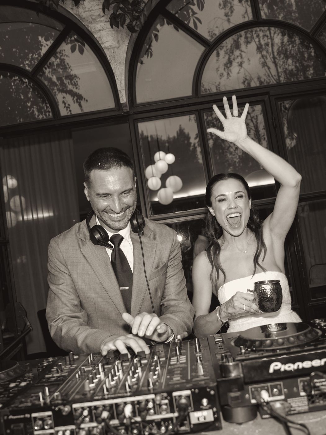 Bride and groom at the DJ booth with the Fuse team